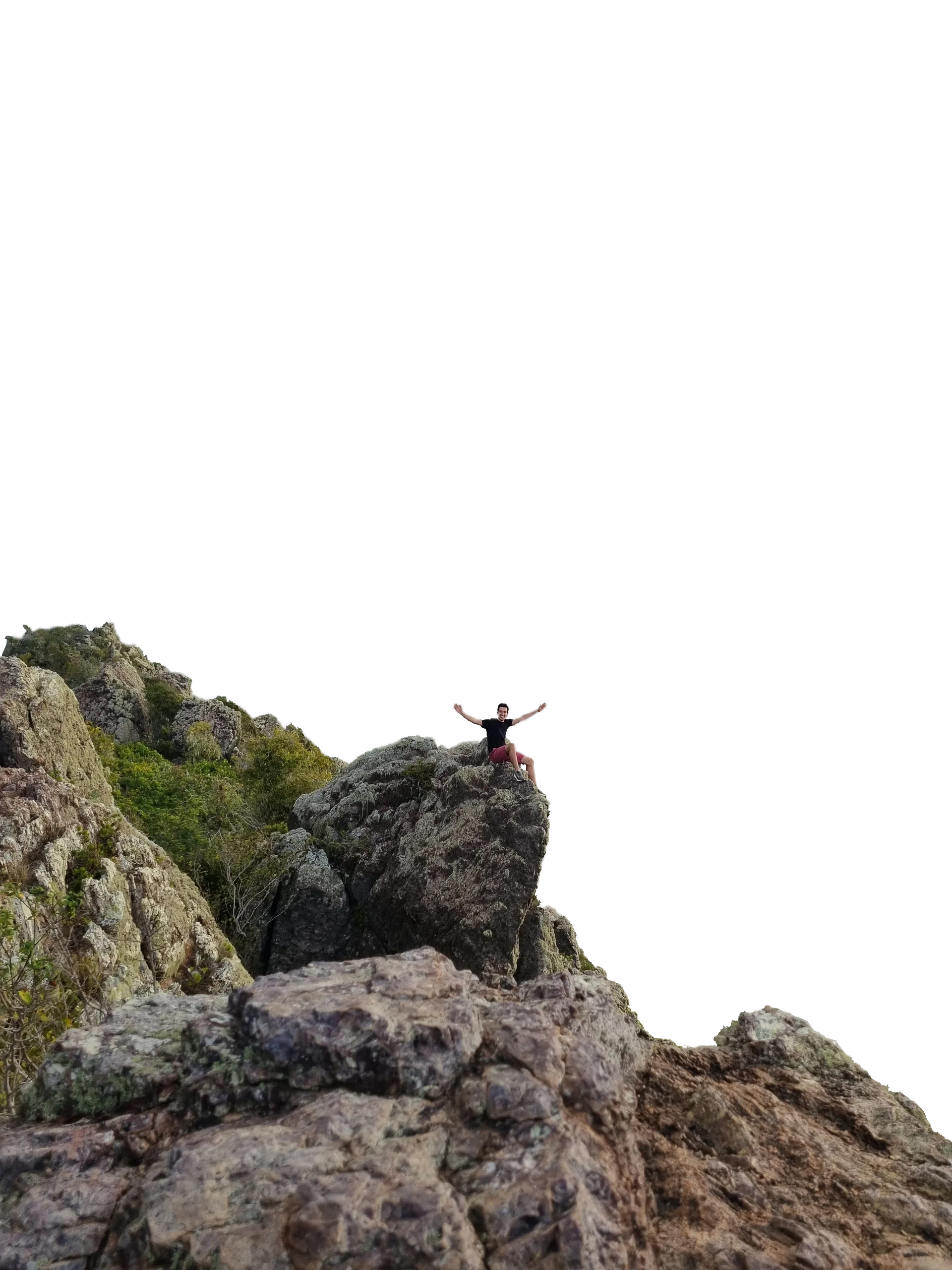 Rafael Correia sitting on a rocky mountain ledge